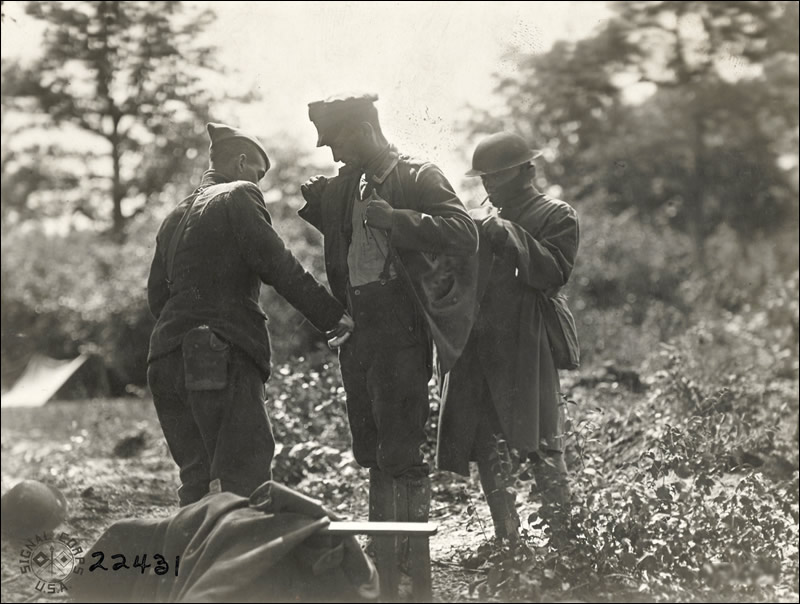Searching prisoners at Hdqrs. 2nd Division. St. Jacques, France. September 12, 1918.